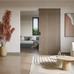 Puerta corredera de madera, ideal para poner puerta corredera sin obra. Un salón moderno con sofá y mesa de centro.