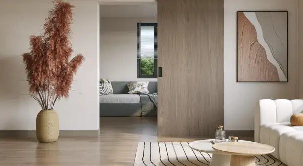 Puerta corredera de madera, ideal para poner puerta corredera sin obra. Un salón moderno con sofá y mesa de centro.